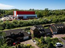 Residents see RED as 59-ft tall scarlet warehouse is built overshadowing their homes - and can't even be used due to planning row