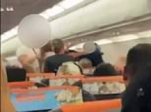 Shocking moment drunken brawl breaks out on easyJet flight as 'woman swigs vodka and spits in passenger's face'