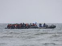 Teenage girl and woman die off French coast as small boat carrying more than 80 migrants 'runs aground' while trying to reach Britain