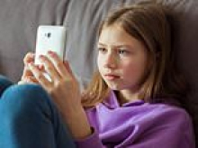 Kids aged 10 more likely to own a phone than know how to throw a ball amid rise of 'iPad kids'