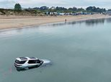 You can't park there, mate! £80,000 Land Rover is flooded after getting trapped in the tide