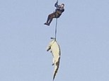 Cop is lowered by helicopter into crocodile-infested river to retrieve dead businessman still INSIDE beast that had eaten him
