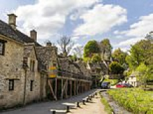 Life on England's prettiest street: Homeowners' battle 'land grabbing' foreign neighbours 'turning the village into a film set and planning warzone renovations'