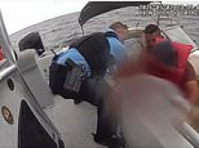 Incredible moment father and son team save six people battling chopping waves after boat sank on Florida lake