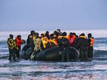 Migrants pile into death-trap dinghies in bid to traverse the Channel as French police watch on and do nothing AGAIN - with number of small boat crossings set to hit 200,000