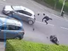 Moment 'teen on stolen motorbike' ploughs into car during police chase - before getting up and running straight into bollard