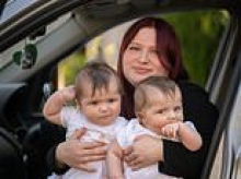 Mother who gave birth to twins inside her partner's BMW after her waters broke a week early says it was 'better than being in hospital'