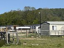 Travellers defy High Court judges at caravan site near Winston Churchill's Kent home: Group who bulldozed field a year ago face jail for continuing building work