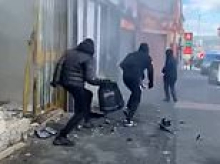 Moment ram-raid thieves armed with bats storm jewellery shop - as terrified customer flees whilst carrying a baby