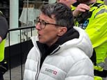 Moment Swatch worker confronts angry crowd desperate for new £335 watch and tells them to go home as 'I have no more to sell' - as brawls, stampedes and chaotic scenes unfold at stores of luxury Swiss brand