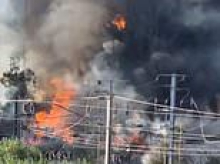 Two London railway lines are out of action after fire breaks out - destroying cars and a caravan