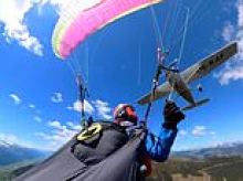 Terrifying moment plane crashes into paraglider, sending her spiralling through the air before emergency parachute saves her