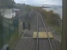 Moment youngsters risk their lives playing on railway tracks as trains speed past