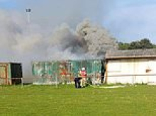 'Screaming' boy, 11, saved by heroic group of fathers after he was trapped in burning storage container - as teen, 13, is arrested over 'attempted murder'