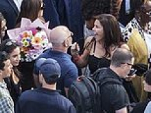 Lauren Sanchez Bezos flashes trademark grin while clinging to husband Jeff at her daughter's graduation... just hours before Blue Origin rocket exploded in huge fireball