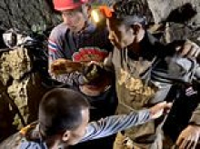 Rescuers free four men who had been trapped in flooded Laos cave for more than a week as two are still missing