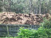 The ten-foot wall of POO at the centre of a furious battle between a mum and her new neighbours - who have now got her surrounded