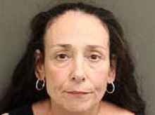 Disney adult from hell, 57, hurled water over restaurant manager and smashed glasses after being told her family was too large to sit at same table, prosecutors say