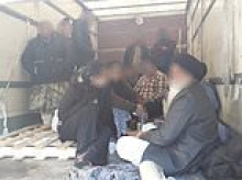 Moment police find Afghan migrants including a child hiding in lorry before Dad's Army trafficking gang pockets £65,000 for organising the trip