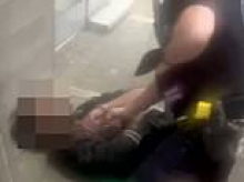 Moment Saudi ex-student, 21, is detained on the ground after 'shooting security guard with crossbow' at Surrey University while injured victim receives medical aid