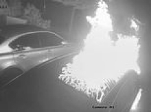 Moment arsonists pour petrol over car at family home of left-wing politician and then set it ablaze - as police probe 'targeted attack'