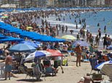 Rampaging Brit is subdued in Benidorm after 'trying to drown woman in the sea and suffocate child, five, in sand'
