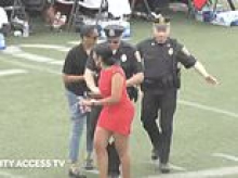 Mom wearing red minidress is carted off during high school graduation ceremony after heckling at mayor for 'wrongdoing with her daughter'