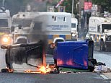 Makeshift barricade is set on fire near homes in Belfast on third night of riots over Sudanese migrant 'knife attack'