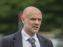 Former Olympic runner, 54, admits throwing pillow at his GP wife during row over noisy electric toothbrush but denies using it to suffocate her