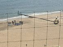 Woman dies after 'suffering medical emergency' in the sea at popular beach - as onlookers tried to save her