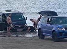 Moment £120,000 Range Rover is swamped by rising tide after owner gets luxury SUV stuck while trying to tow friend's van