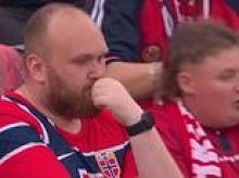 The ONE Norwegian fan refusing to join in with team's viral World Cup celebration! Hilarious moment single supporter sits still as thousands do 'The Viking'