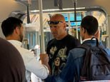 Moment Elizabeth line passengers rush to man's defence after he is slapped by insult-hurling stranger on busy carriage - then force attacker to apologise
