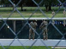 Trump erects fence around Reflecting Pool to deter vandals as foul-mouthed activist arrested for berating troops