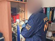 Police release images of cannibal's lair filled with human bones - and trophy cabinet containing skull and reconstructed face made from skin
