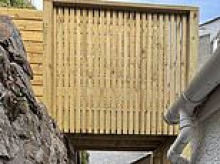 Homeowner ordered to tear down 'overbearing' wooden bridge he built to climb up his steep garden - after inspectors called it 'unneighbourly'