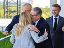Keir-miserations: Ousted Starmer gets consolation hugs from European leaders at Berlin summit as departing PM makes one of his final foreign trips