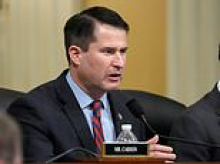 Democrat congressman appears to slap down camera when cornered about support for Nazi tattoo wearing Senate candidate