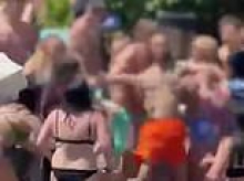 Moment British girl, 13, is punched in the face 'by Spanish thug as brawl breaks out over her sitting on someone's sun lounger' at hotel