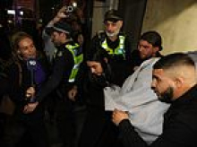 Chaotic scenes as an ISIS bride accused of slavery offences is shielded by police and loved ones after being freed from custody