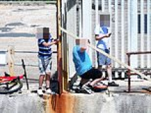 The battle for a French-owned beach...in Sussex: Moment teenagers scale fence to cool off in the sea - after firm stopped locals using it for 18 years