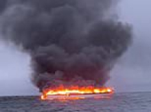 Four people rescued from yacht as vessel bursts into flames off the English coast