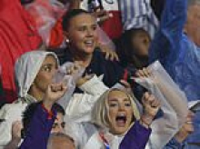 Kate Kane and Megan Pickford celebrate in the stands as their Three Lions husbands beat Mexico