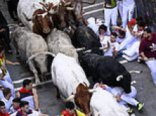 Pamplona bull-runners are tossed around and trampled with at least three injured under the hooves of rampaging animals as famed festival begins