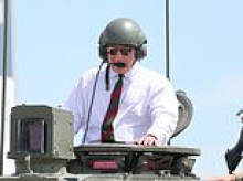 Here comes His Majesty! King Charles driven around in army tank during visit to Dorset regiment...as Royal Family 'shut out noise' around Prince Harry's visit