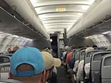 Hellish nightmare for hundreds of American Airlines passengers forced to sit on sweltering runway 3 hours AFTER their flights landed