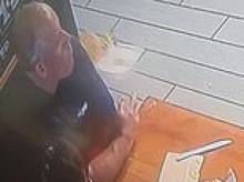 Middle-aged man with America's WORST table manners sparks fury by chewing with his mouth open and hurling food on floor at bagel bakery
