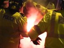 Terrifying moment police officer goes up in flames as Polish hooligans launch 'worst football violence seen in decades' on British streets