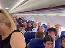 Moment angry passengers revolt on Wizz Air flight from Luton after being trapped in 37.7C heat without air con as delayed plane sits on runway