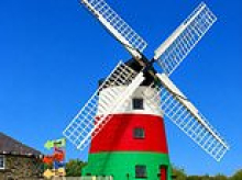 Owner of 250-year-old Grade II-listed windmill sparks row as he gives it a colourful makeover without permission